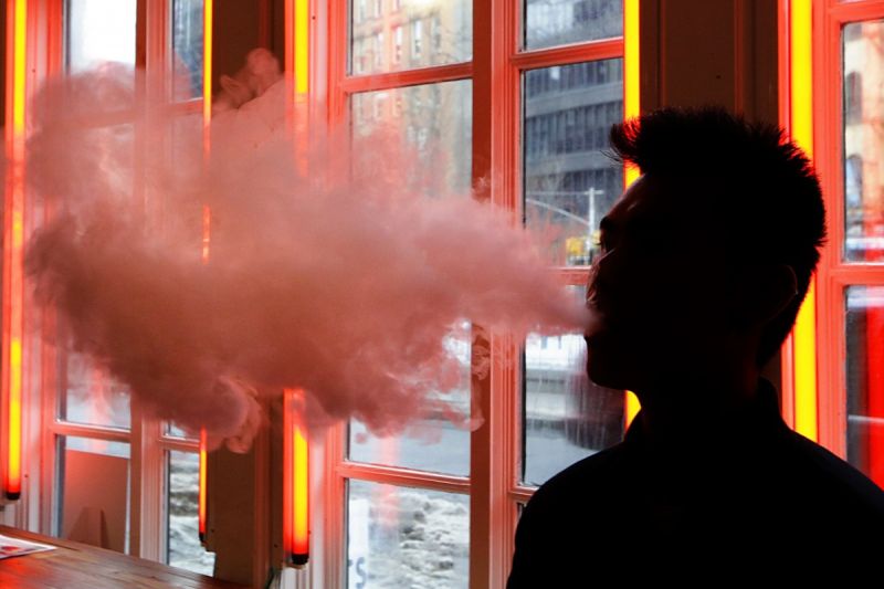 man blowing smoke from vape