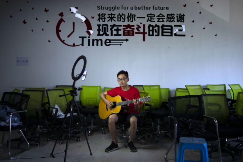 man playing guitar on live stream in china